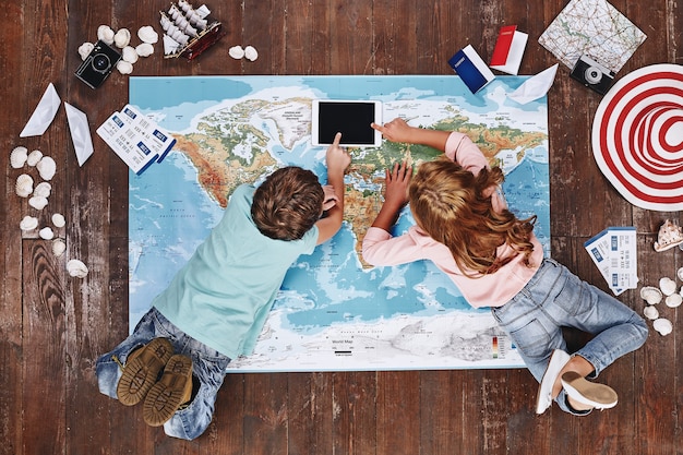 An image of a group of people planning their trip for the upcoming holidays, scattered with maps, travel guides, and festive decorations, symbolizing the excitement of planning vacations.