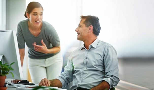 A leader having a one-on-one conversation with an employee in a relaxed office setting, demonstrating active listening and empathy. The leader is making eye contact and showing genuine interest in what the employee is saying.