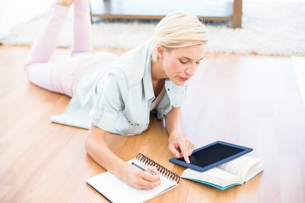 A woman writing in a journal while sitting in a comfortable position, planning her 30-day yoga routine, surrounded by yoga mats and equipment.