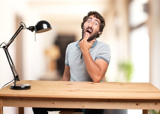 A person yawning and looking tired at their desk, symbolizing fatigue as a sign of vitamin D deficiency. The scene shows a typical office environment.