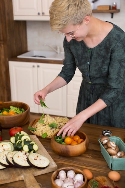 A photo of a person preparing a meal at home, highlighting organization and a variety of fresh ingredients on the countertop.