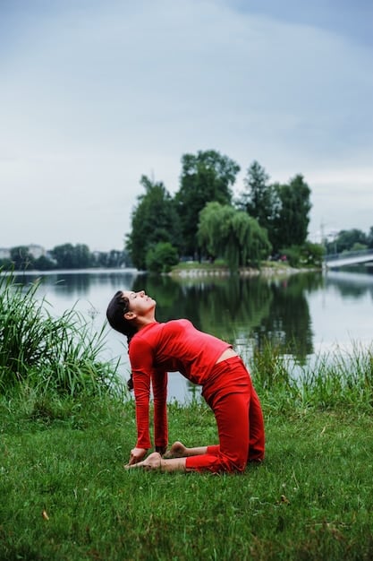 A serene image of a person practicing yoga or tai chi in a peaceful natural setting, such as a park or beach at sunrise. The focus should be on the individual's calm expression and posture, conveying the mental and emotional benefits of these physical activities.