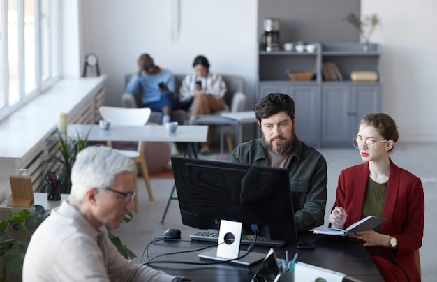 A modern office space with employees collaborating on laptops and tablets, reflecting the theme of adapting to new labor laws and technological changes in the workplace.