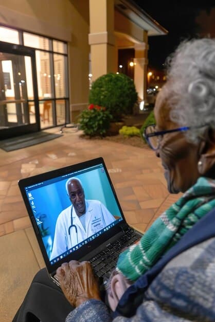 A doctor using telemedicine technology to consult with a patient in a remote rural area of Brazil, symbolizing the use of technology to improve access to healthcare in underserved communities.