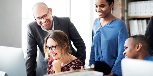A diverse group of people working in an office, symbolizing economic activity and potential job growth.