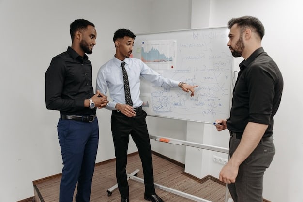 Three professionals are standing in front of a whiteboard discussing performance reviews, with graphs and charts illustrating their accomplishments. The scene highlights the importance of presenting results during salary negotiation discussions.