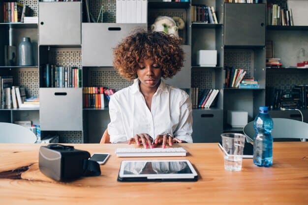 A person sitting at a desk, using a tablet to research a company before applying for a job, emphasizing the importance of company research for resume customization in 2025.