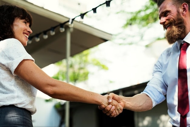 A close-up shot of two professionals shaking hands warmly at a networking event in Brazil, capturing the moment of connection and trust-building. The background is slightly blurred, focusing on the handshake.