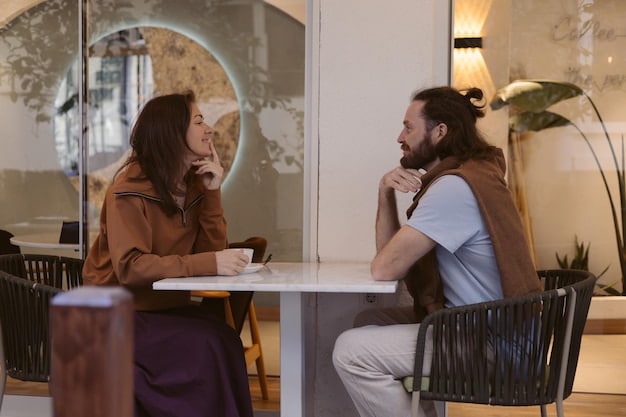 A mentor and mentee sitting in a sunlit cafe, engaged in a deep conversation. The mentor is gesturing with warmth and encouragement, while the mentee listens attentively with a notebook in hand. Capture the ambiance of trust, guidance, and mutual respect in a casual setting.