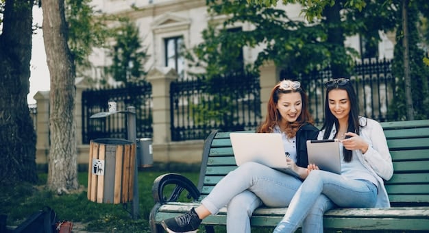 A modern university campus with students using laptops outdoors, showcasing a blend of traditional and digital learning environments for post-graduate studies under the new tax regulations.