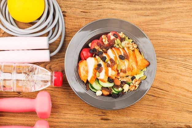 A close-up shot of a plate with a balanced meal designed for a pre-workout energy boost. The plate includes complex carbohydrates like brown rice, lean protein such as grilled chicken, and a side of green vegetables. The lighting is bright and emphasizes the freshness and healthiness of the food.