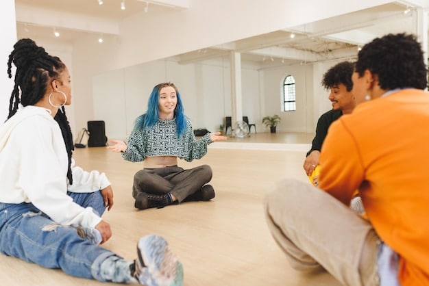 A group of diverse individuals participating in a guided meditation session indoors, sitting comfortably on cushions in a circle. Soft lighting and potted plants create a calming atmosphere. The facilitator is speaking gently, guiding the group through the meditation practice.