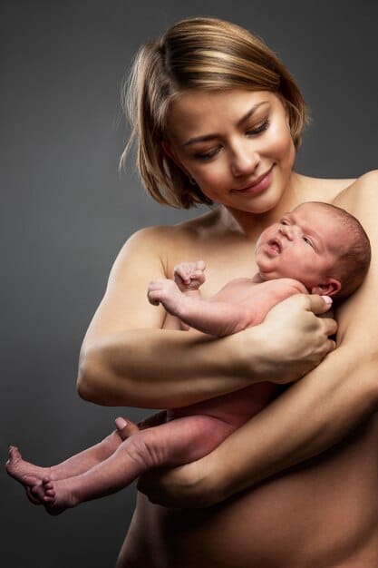 A serene image of a new mother holding her newborn baby skin-to-skin, emphasizing the bond between them and the nurturing aspect of postpartum care. The lighting should be soft and natural.
