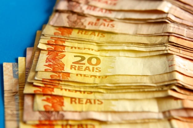 A close-up view of the Brazilian Real currency notes and coins, arranged in a way that shows both front and back details and the varying denominations, symbolizing monetary policies and economic values in Brazil.