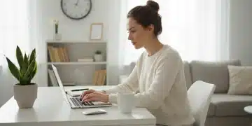 Professional woman focused on her laptop in a modern remote work setup, embodying productivity.